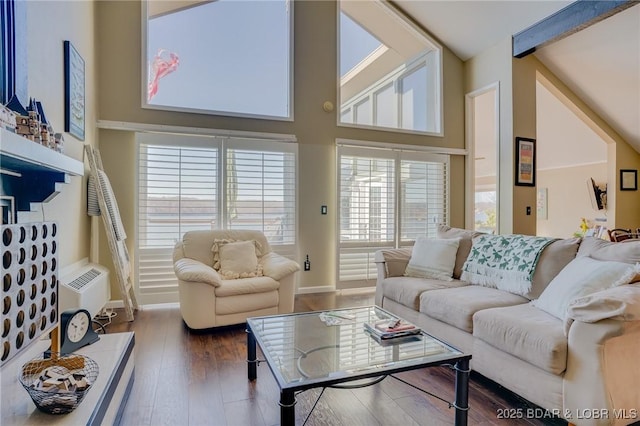 living room with dark hardwood / wood-style flooring and a wall unit AC