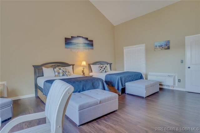 bedroom with high vaulted ceiling and hardwood / wood-style floors