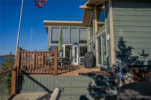 wooden terrace featuring a grill