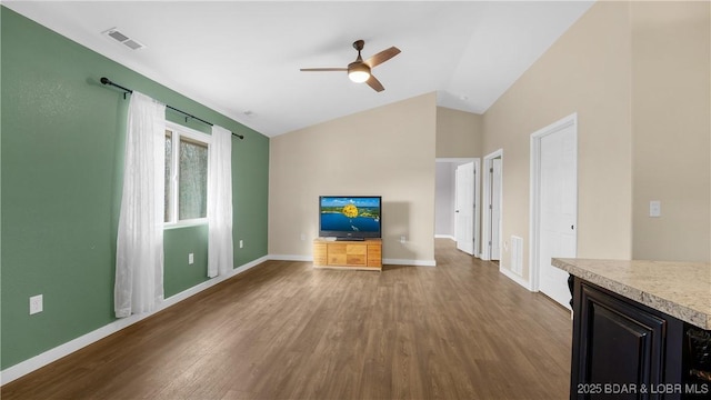 unfurnished living room featuring vaulted ceiling, ceiling fan, and hardwood / wood-style flooring