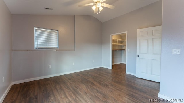 unfurnished room with ceiling fan, lofted ceiling, and dark hardwood / wood-style flooring