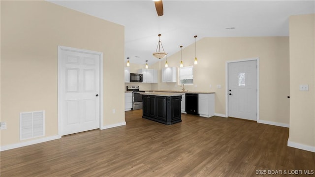 kitchen featuring decorative light fixtures, a center island, black appliances, dark wood-type flooring, and white cabinets