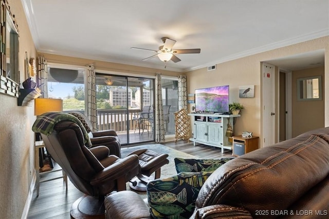 living room featuring ceiling fan, dark hardwood / wood-style floors, and ornamental molding