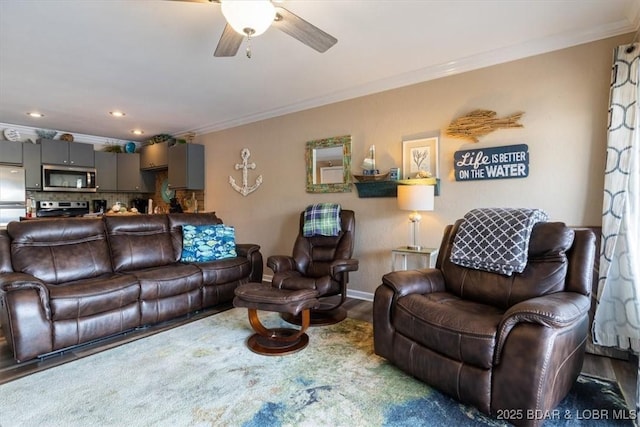 living room with ceiling fan, carpet, and ornamental molding