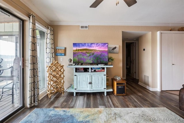 living room with ceiling fan, crown molding, and dark hardwood / wood-style floors