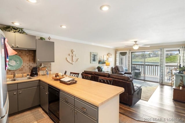 150 Southwood Shores Dr Unit 23-2B, Lake Ozark, MO 65049 - kitchen with gray cabinets, a peninsula, dishwasher, light countertops, and crown molding