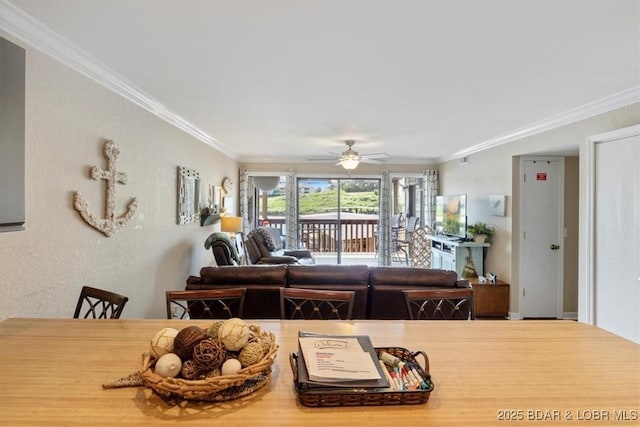 dining room with ceiling fan and crown molding