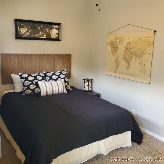 bedroom with carpet flooring and baseboards