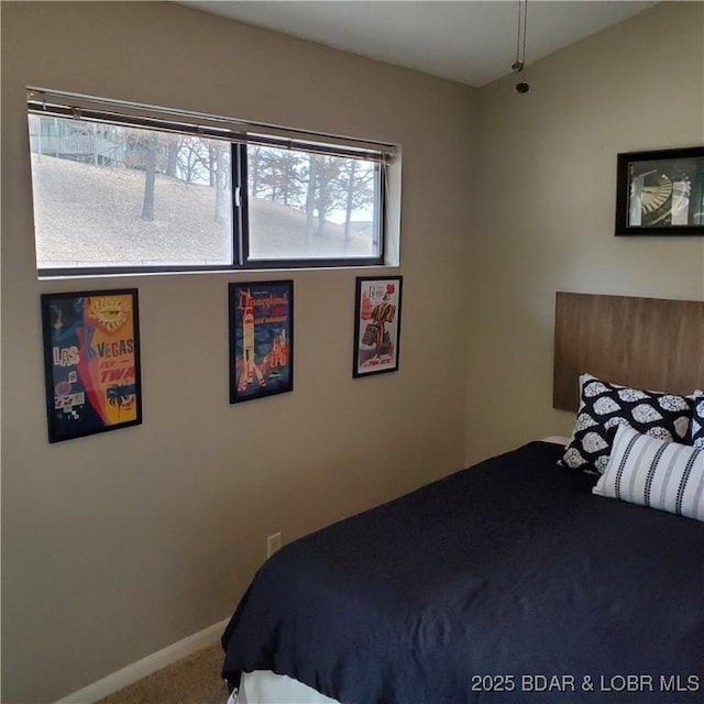 carpeted bedroom featuring baseboards