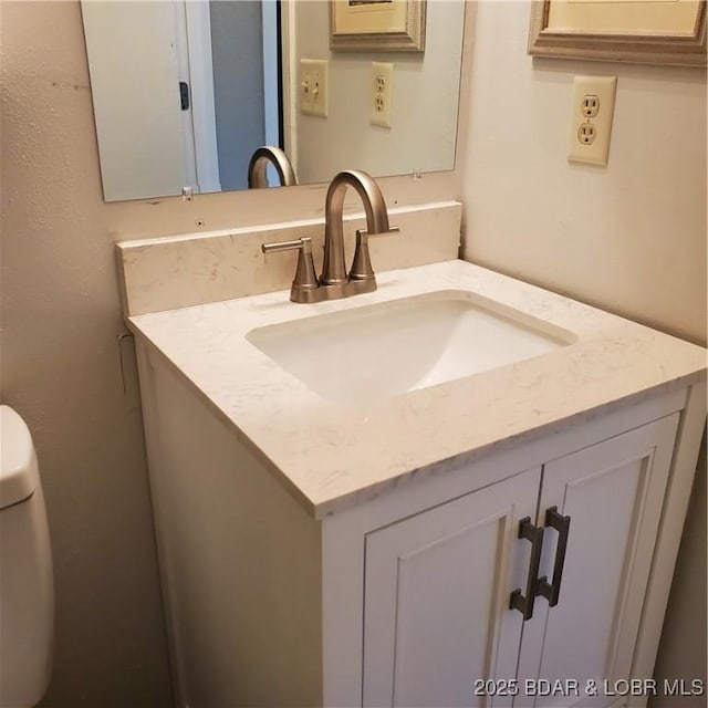 bathroom featuring toilet and vanity