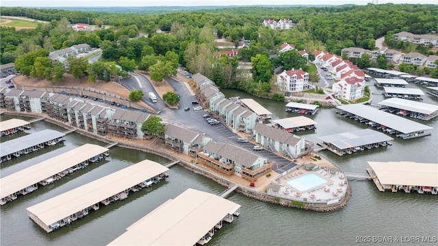 birds eye view of property featuring a water view and a view of trees