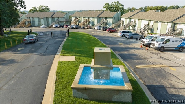 view of road with stairs, a residential view, and curbs