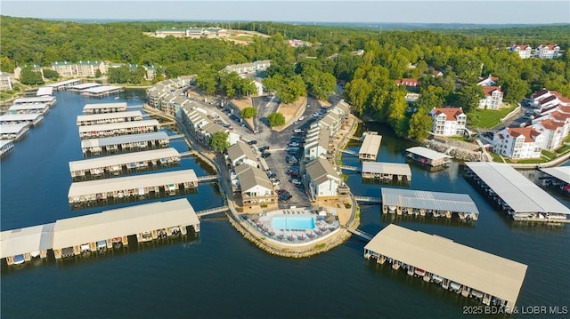 aerial view with a water view and a wooded view