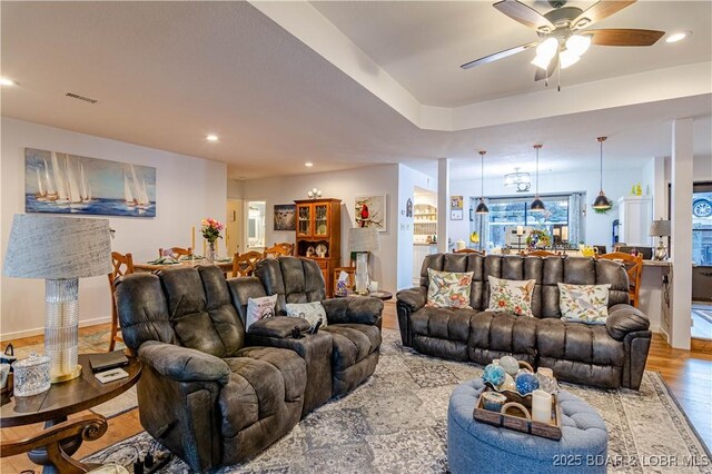 living room featuring light wood-type flooring and ceiling fan