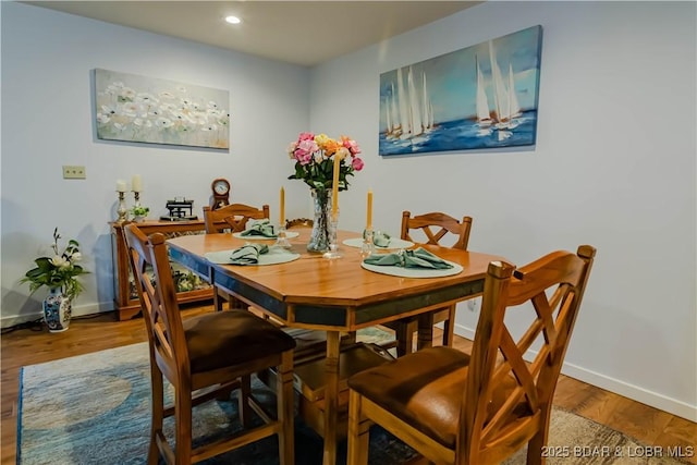 dining room with recessed lighting, wood finished floors, and baseboards