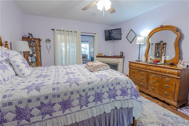 bedroom with ceiling fan and light hardwood / wood-style flooring