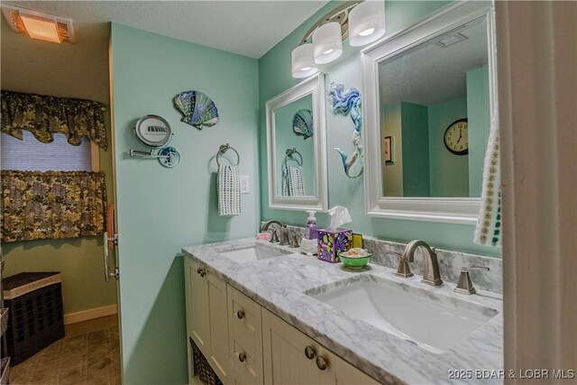 bathroom with a textured ceiling and vanity