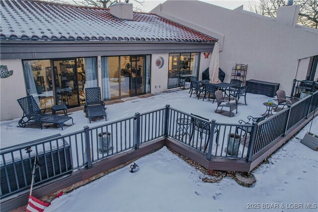 view of snow covered rear of property