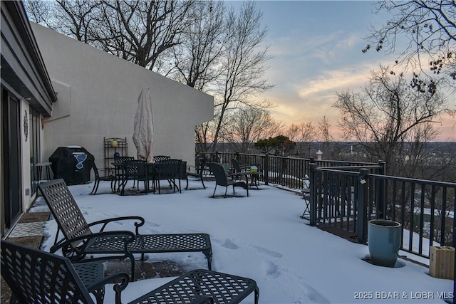 snow covered patio featuring area for grilling