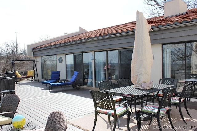 wooden deck featuring outdoor dining area