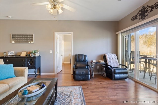 living room featuring ceiling fan and wood-type flooring