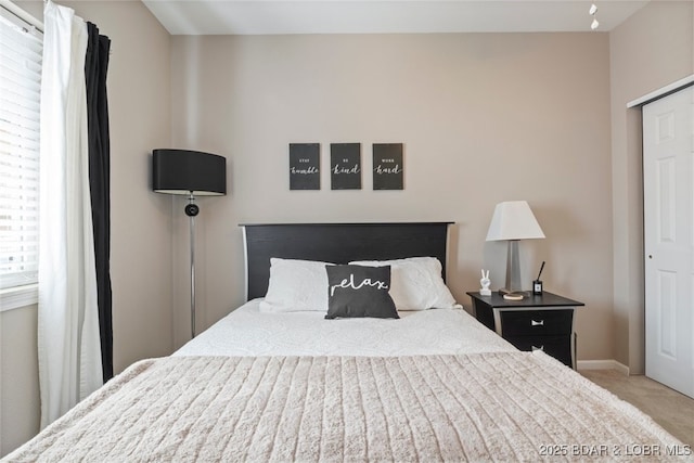 carpeted bedroom with a closet