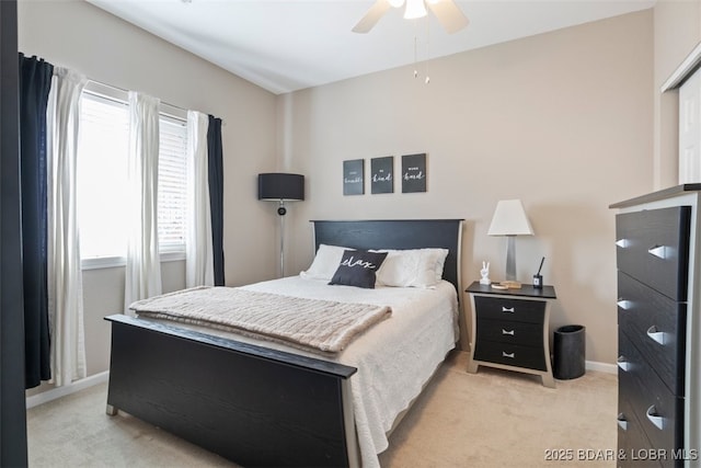 bedroom with ceiling fan and light colored carpet