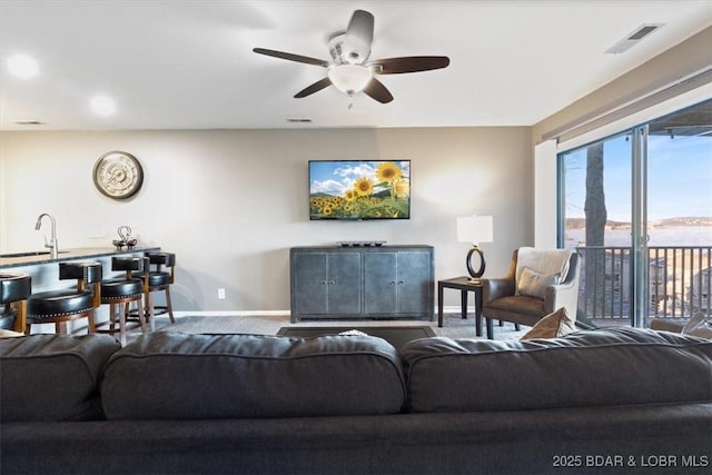 711 Indian Pointe Dr Unit 711, Osage Beach, MO 65065 - living area featuring visible vents, a ceiling fan, and baseboards