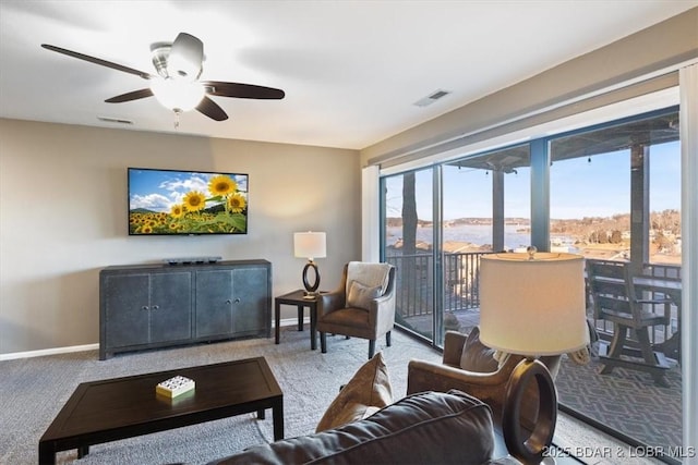 carpeted living room featuring ceiling fan