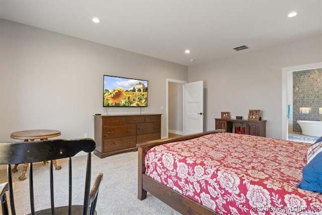 bedroom with light carpet and connected bathroom