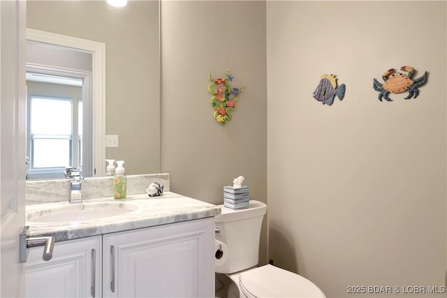 bathroom with toilet and vanity