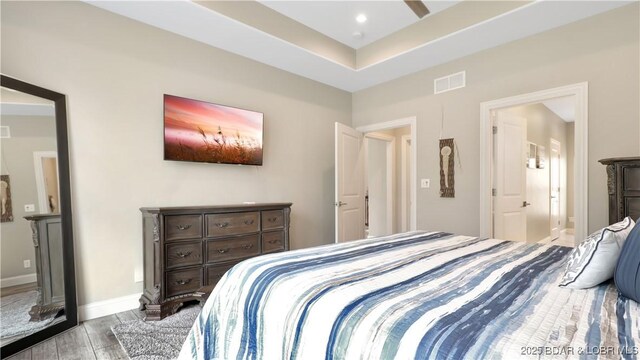 bedroom featuring light wood-type flooring and connected bathroom