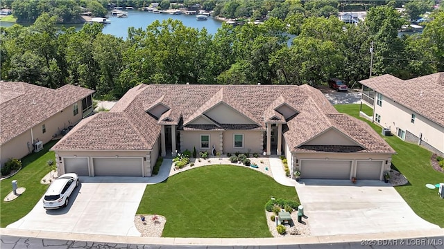 view of front of home with a water view and a front lawn