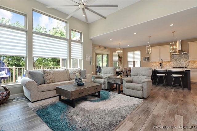 living room with light wood-type flooring and an inviting chandelier