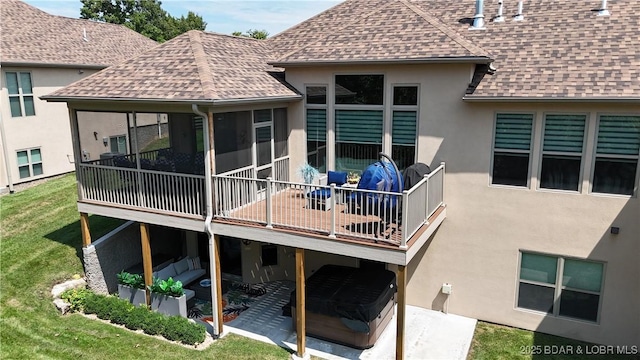 rear view of house featuring a patio area and a lawn