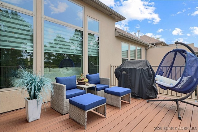 wooden terrace featuring area for grilling and outdoor lounge area