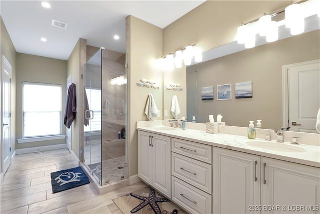 bathroom featuring vanity, a shower with shower door, and tile patterned floors