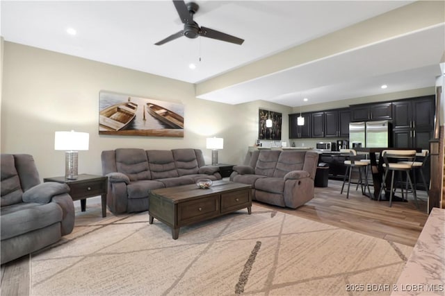 living room featuring ceiling fan and light wood-type flooring