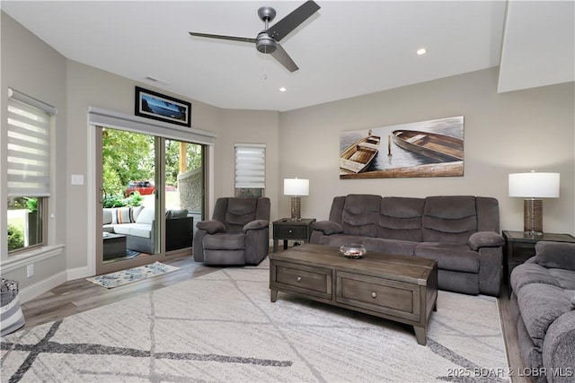 living room with ceiling fan and light wood-type flooring