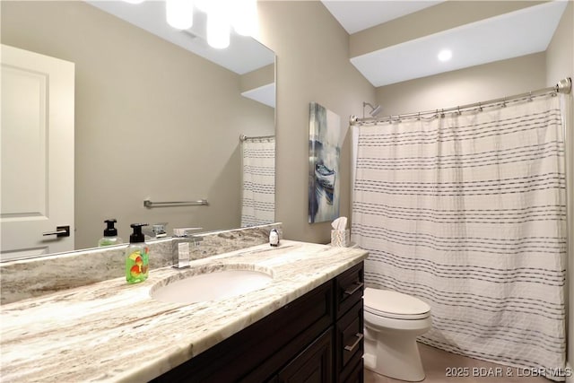 bathroom featuring vanity, toilet, and curtained shower