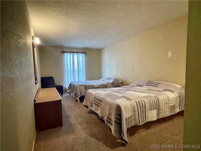 carpeted bedroom featuring a textured ceiling