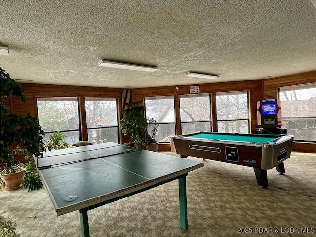 game room with billiards, wood walls, a textured ceiling, and carpet floors