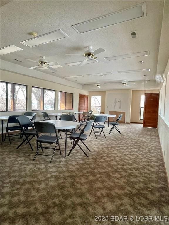 unfurnished dining area featuring a textured ceiling and a wealth of natural light