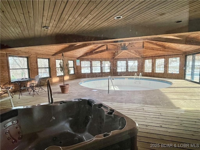 view of swimming pool featuring an indoor hot tub