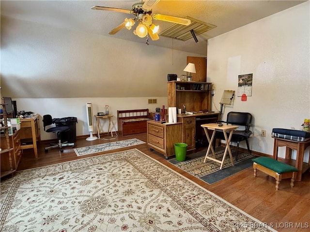 home office featuring ceiling fan, hardwood / wood-style floors, and lofted ceiling