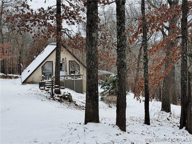 yard covered in snow featuring a wooden deck