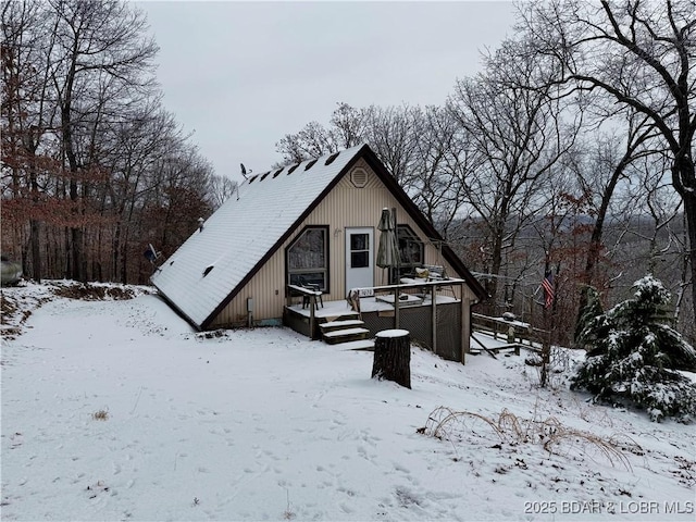 snow covered property featuring a deck