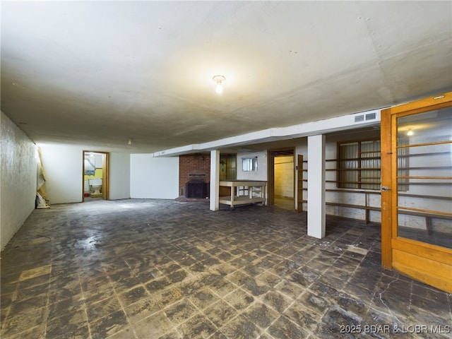 basement featuring a brick fireplace