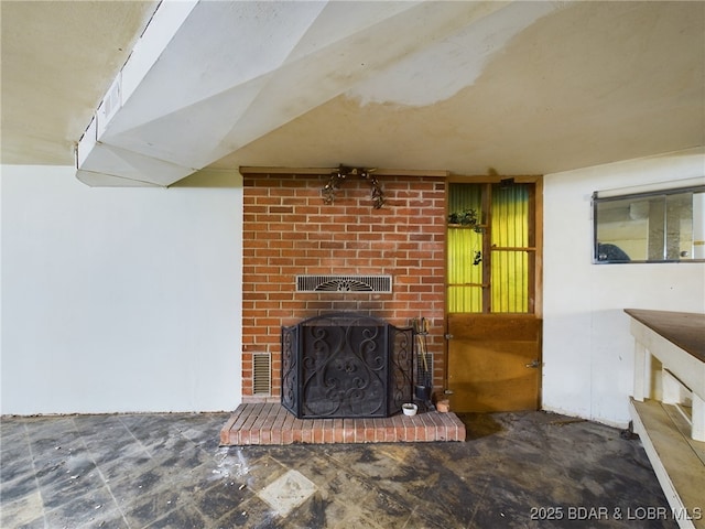 living room featuring a brick fireplace