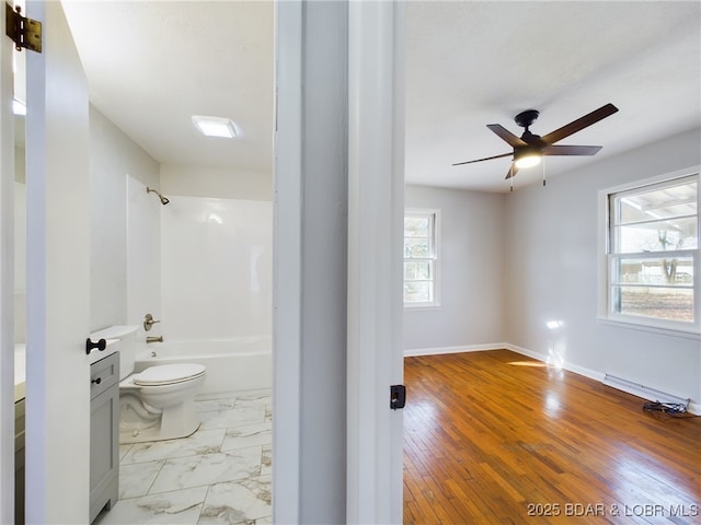 full bathroom with toilet, vanity, a wealth of natural light, and shower / bathing tub combination